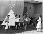 Students outside Candalaria Hall with a model tipi