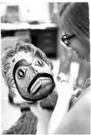 Nellie Denning looking at painted mask