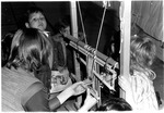 Children observing loom exhibit