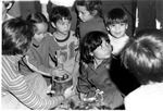 Children using wooden mortar and pestle