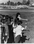 Scott Elementary School students playing hoop and arrow game by Dan Wooley