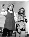 Two girls playing hoop and arrow game