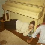 Sandy Duval sleeping under a piano