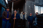 Members of the Tlingit Tribe pause for comments in front of the Bear Clan House at Angoon, Alaska, November 1, 2003 by Kevin Moloney
