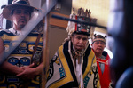 Tlingit Tribe members stand before the Bear Clan Totem on October 20, 2003 by Kevin Moloney